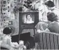  ?? AP ?? A British family watches Queen Elizabeth II ona television during her first Christmas telecast in 1957.