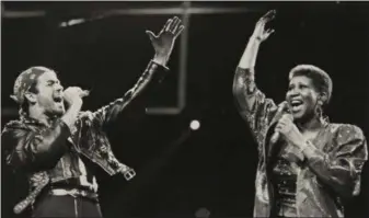  ?? ROB KOZLOFF — AP FILE PHOTO ?? In this Aug. 30, 1988 file photo, Aretha Franklin joins George Michael during his Faith World Tour in Auburn Hills, Mich. Franklin died Thursday at age 76 after a long period of illness.