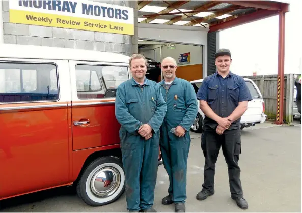  ??  ?? The team at Murray Motors (trading as P E Crook Ltd) work on all types of vehicles from this Combi van to the near new ute in the background. They are from left mechanic Johnny Veneberg, owner/mechanic Murray Dickens and apprentice mechanic Josh Wickens.
