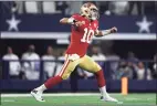  ?? Tom Pennington / Getty Images ?? Niners quarterbac­k Jimmy Garoppolo celebrates after a first down against the Cowboys on Sunday.