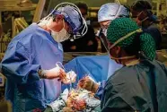  ?? Karen Warren/Staff file photo ?? Surgeons prepare for a heart transplant. The national transplant system has been criticized for wait times and inequities.