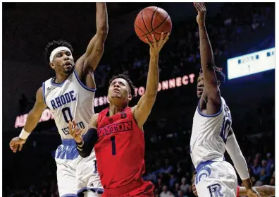  ?? DAVID JABLONSKI / STAFF ?? A tattoo on the left arm of Darrell Davis (1) is a constant reminder of his “best teammate” with UD, Steve McElvene, the Flyers’ beloved 6-foot-11 center, who died suddenly two years ago from an enlarged heart. He was just 20.