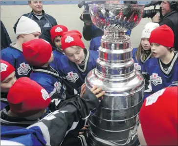  ?? Gavin Young/calgary Herald ?? The Lake Bonavista Atom 5 Breakers had a big surprise waiting for them when they showed up for practice Saturday: the Stanley Cup. The team was picked at random by the Scotiabank Community Hockey Sponsorshi­p Program.