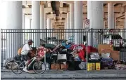  ?? Yi-Chin Lee / Houston Chronicle ?? People’s belongings are piled up at U.S. 59 at Congress Avenue, where many homeless people set up camp.