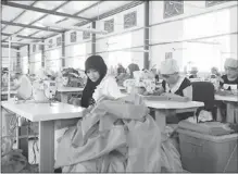  ??  ?? Workers make clothes at Yinchuan Wantini Clothing Co Ltd.
