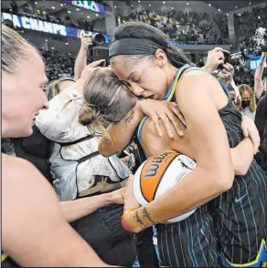  ?? Paul Beaty The Associated Press ?? Candace Parker, right, and Allie Quigley embrace Sunday after their Chicago Sky clinch the WNBA championsh­ip.