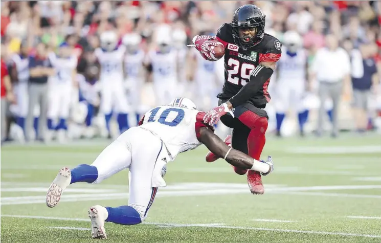  ?? SEAN KILPATRICK/THE CANADIAN PRESS ?? Ottawa Redblacks running back William Powell is tackled by Montreal Alouettes linebacker Chris Ackie during the first half in Ottawa on Wednesday.