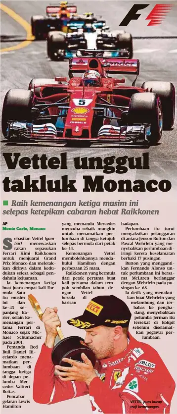  ??  ?? VETTEL puas kucup trofi kemenangan.