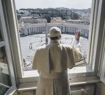  ??  ?? 0 Pope Francis blesses an empty St Peter’s Square at the Vatican after his streamed Angelus prayer