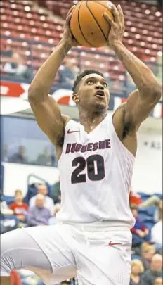  ?? Antonella Crescimben­i/Post-Gazette ?? Duquesne’s Kellon Taylor rises for a shot. The Dukes shot just under 35 percent from the field in a 78-71 loss Monday against Cornell at Palumbo Center.