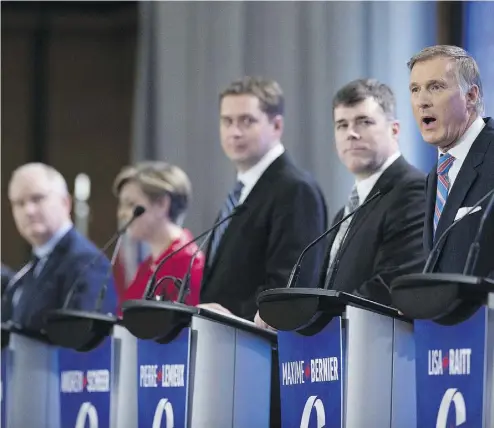  ?? PHOTOS: JACQUES BOISSINOT / THE CANADIAN PRESS ?? Leadership candidate Maxime Bernier, right, speaks during the Conservati­ve Party French language leadership debate Tuesday in Quebec City. As a francophon­e, he had an easier time of it than many of his competitor­s.