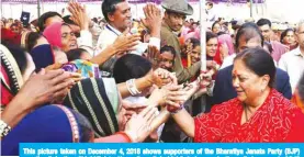  ?? — AFP ?? This picture taken on December 4, 2018 shows supporters of the Bharatiya Janata Party (BJP) greeting Rajasthan Chief Minister Vasundhara Raje (right) during an election rally in support of BJP candidates in Kotri village in Rajasthan state’s Bhilwara district.