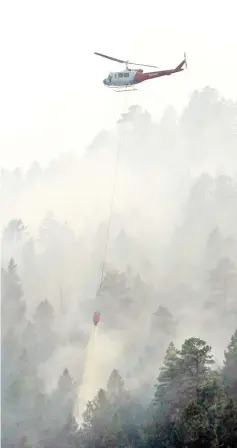  ?? —Reuters photo ?? A helicopter drops water on the 416 Fire near Durango, Colorado, US.