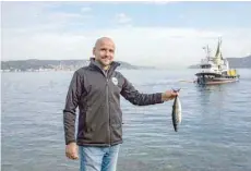  ?? — AFP ?? Angler Mehmet Dogan poses for a photograph on the bank of the Bosphorus.