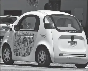  ?? TRIBUNE NEWS SERVICE ?? A Google self-driving car moves along the roadway at the company's headquarte­rs in Mountain View.