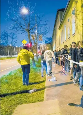  ??  ?? People queued to vote in Budapest after the official closing time and Prime Minister Viktor Orban, right, won easily.