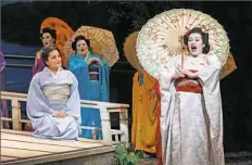  ?? David Bachman Photograph­y ?? Cio-Cio San (Dina Kuznetsova), right, and her friends arrive while her maid Suzuki (Laurel Semerdjian) watches in the Pittsburgh Opera production of “Madama Butterfly.”