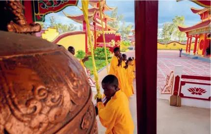  ?? ?? A disciple tolls a bell in the Shaolin Temple in Zambia