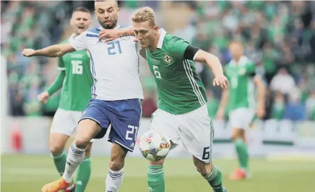  ??  ?? Middlesbro­ugh and Northern Ireland’s George Saville (right) and Bosnia and Herzegovin­a’s Elvis Saric battle for the ball.