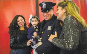  ?? Andres Kudacki / Associated Press ?? Matias Ferreira celebrates Friday with his daughter, Tianna, his wife, Tiffany (left), and his mother at the Suffolk County Police Academy in Brentwood, N.Y.