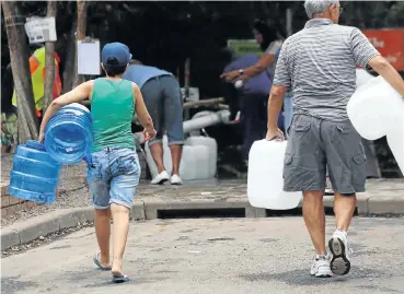  ?? Picture: Esa Alexander ?? Capetonian­s of all income levels are coming to terms with the fact that water will soon stop flowing from their taps and they will have to collect their 25-litre daily quota from central points.