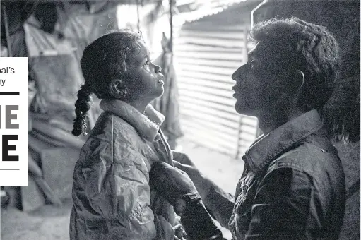  ??  ?? Sanika weeps over the departure of her father, who tries to comfort her. Jadibuti, Nepal.