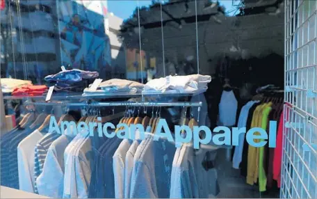  ?? Justin Sullivan Getty Images ?? THE EMERGENCE of e-commerce and declining customer traffic at many malls are among the factors shortening the life cycle for many fashion brands, analysts say. Above, an American Apparel store in L.A. The brand was sold in a bankruptcy auction to a...