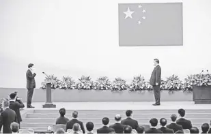  ?? AP ?? China’s President Xi Jinping, right, looks on as hong Kong’s incoming Chief Executive John Lee is sworn in as the city’s new leader, during a ceremony to inaugurate the city’s new government in hong Kong on Friday, July 1, 2022, on the 25th anniversar­y of the city’s handover from Britain to China.