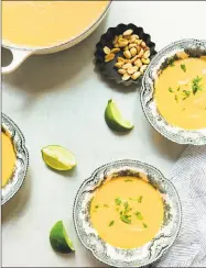  ??  ?? Pumpkin soup adorns a fall table.