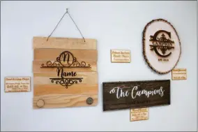  ?? LAUREN HALLIGAN - MEDIANEWS GROUP ?? Saratoga Custom Engraving features many engraved wooden signs.