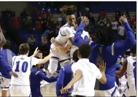  ?? (Arkansas Democrat-Gazette/Thomas Metthe) ?? Nevada’s Javontae Pearson (top center) celebrates with teammates Thursday after the Blue Jays’ 48-47 victory over Izard County for the Class 1A boys state championsh­ip at Bank OZK Arena in Hot Springs. More photos at arkansason­line.com/313boys1a/.