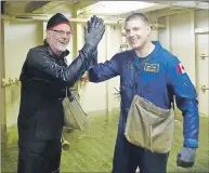  ?? JONATHAN RILEY/TC MEDIA ?? Truro Daily News reporter Jonathan Riley and Canadian astronaut Jeremy Hansen teamed up to plug a leak in a flood simulator at the Kootenay Damage Control Training Facility near Halifax.