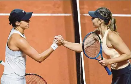  ?? AFP PIC ?? Maria Sharapova (right) congratula­tes Caroline Garcia for beating her in the first round of the Stuttgart Grand Prix in Germany on Tuesday.