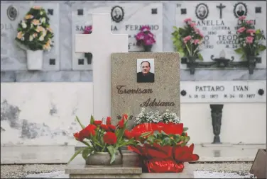  ??  ?? Flowers adorn the tombstone of Adriano Trevisan, Italy’s first known victim of covid-19, at the cemetery of Vo Vecchio in Vo Euganeo.