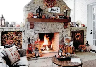  ?? [PHOTOS PROVIDED BY KIRKLAND’S] ?? Pumpkins on the hearth, a fall throw pillow, maple leave wreaths and a “Spooky” sign are simple moves that create a seasonal feeling at home.