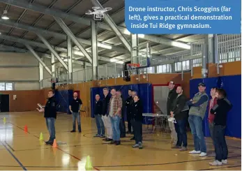  ??  ?? Drone instructor, Chris Scoggins (far left), gives a practical demonstrat­ion inside Tui Ridge gymnasium.