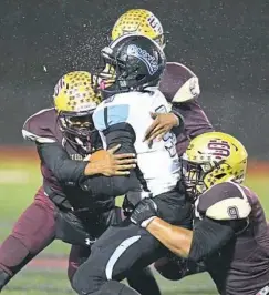  ??  ?? Above: Tayshawn Levy of Washington is brought down by Steel Valley’s NiJhay Burt, from left, Kameron Williams and Todd Hill.