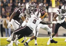  ?? David J. Phillip / Associated Press 2019 ?? South Carolina’s Javon Kinlaw tackles Texas A&M quarterbac­k Kellen Mond in a game on Nov. 16 in College Station, Texas. Kinlaw had six sacks in his senior season.