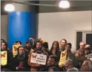  ??  ?? Community members both for and against a sanctuary city resolution, gather at a Troy City Council meeting.