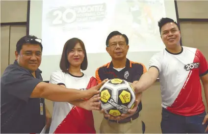  ?? SUNSTAR FOTO/RUEL ROSELLO ?? READY TO GO. Organizers of the 20th Aboitiz Cup (from left) Glen Quisido (left) and Cebu Football Associatio­n president Ricky Dakay (second from right) with AboitizLan­d’s Farah Mayol (second from left) and Carlo Tenerife (right) during the launching of the 20th edition of the tournament.