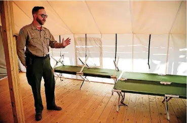  ?? [PHOTO BY JESSIE WARDARSKI, TULSA WORLD] ?? Osage Hills State Park Manager Nick Conner explains the design and intrigue of staying in one of the park’s two traditiona­l canvas wall tents.