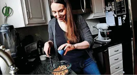  ?? [PHOTO BY KATHERINE FREY, THE WASHINGTON POST] ?? Recipe developer and food photograph­er Jennifer Farley works on roasted Salt-and-Pepper Cashews.