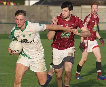  ??  ?? Conor Devereux of Crossabeg-Ballymurn brushes Multyfarnh­am’s Brian McLoughlin aside.