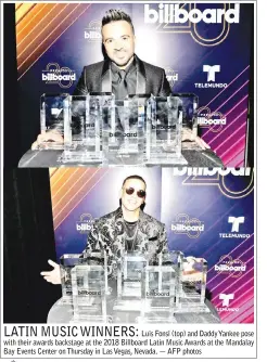  ??  ?? Luis Fonsi (top) and Daddy Yankee pose with their awards backstage at the 2018 Billboard Latin Music Awards at the Mandalay Bay Events Center on Thursday in Las Vegas, Nevada. — AFP photos