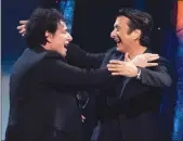  ??  ?? Inductees Neal Schon, left, and Steve Perry from the band Journey embrace at the 2017 Rock and Roll Hall of Fame induction ceremony on Friday.