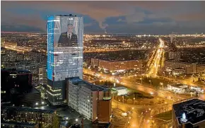  ?? AP ?? An image of Russian President Vladimir Putin, speaking during his annual state of the nation address, is shown on an electronic screen, installed on the facade of a tower in St Petersburg.