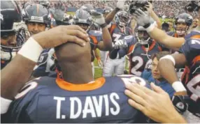  ?? John Leyba, Denver Post file ?? Teammates mob Terrell Davis on the field in Denver in 2002 after he announced his retirement from football.