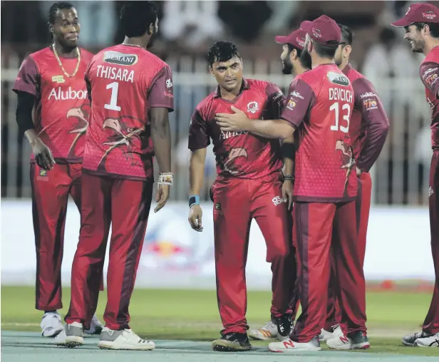  ?? Photos from Sharjah by Chris Whiteoak / The National ?? Pravin Tambe, third from left, and the Sindhis stunned T10 League champions Kerala Knights