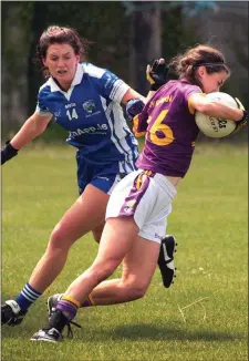  ??  ?? Ellen O’Brien ofWexford is tackled by Emma Lawlor (Laois) in the TG4 Leinster Intermedia­te championsh­ip semi-final in Bellefield.