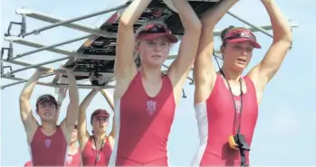  ??  ?? ST MARY’S 1st quad carry their boat off the jetty, after the narrowest of wins.